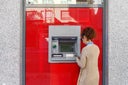 Latin woman using ATM