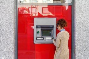 Latin woman using ATM