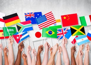 Human Hands Holding National Flags