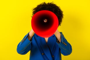 art african woman looking through a spyglass bright color picture. Fashion and beauty concept