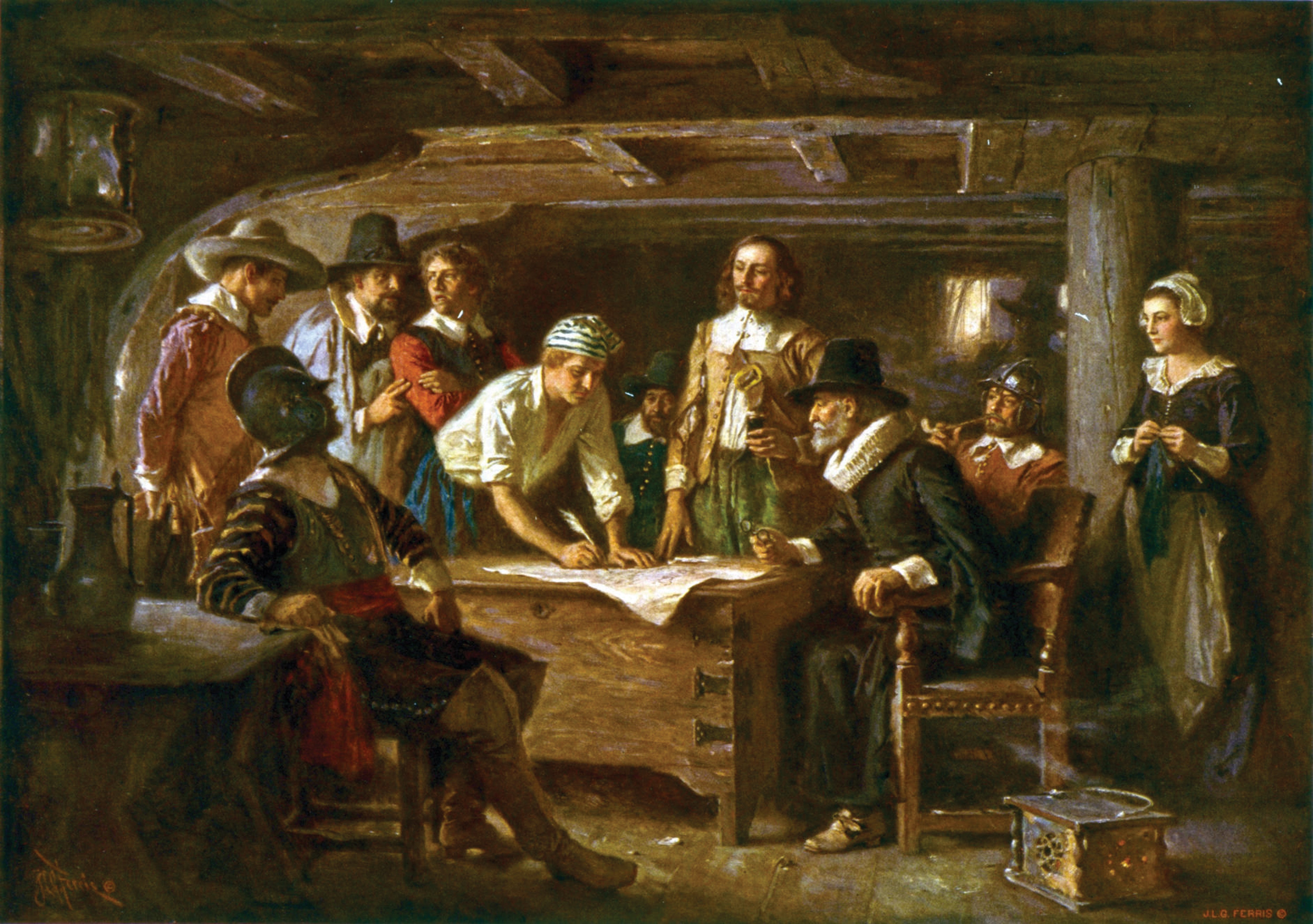 A group of people gathered around a table looking at a document.