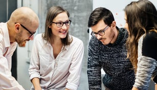 Team working ambitiously in an office room.