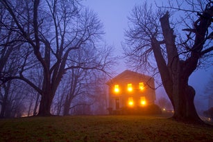 Old stone house on foggy night