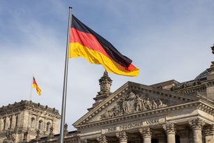 Deutscher Bundestag - Reichstag building with German flags (German parliament building) - Berlin, Germany