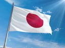 Japan National Flag Waving on pole against sunny blue sky background. High Definition