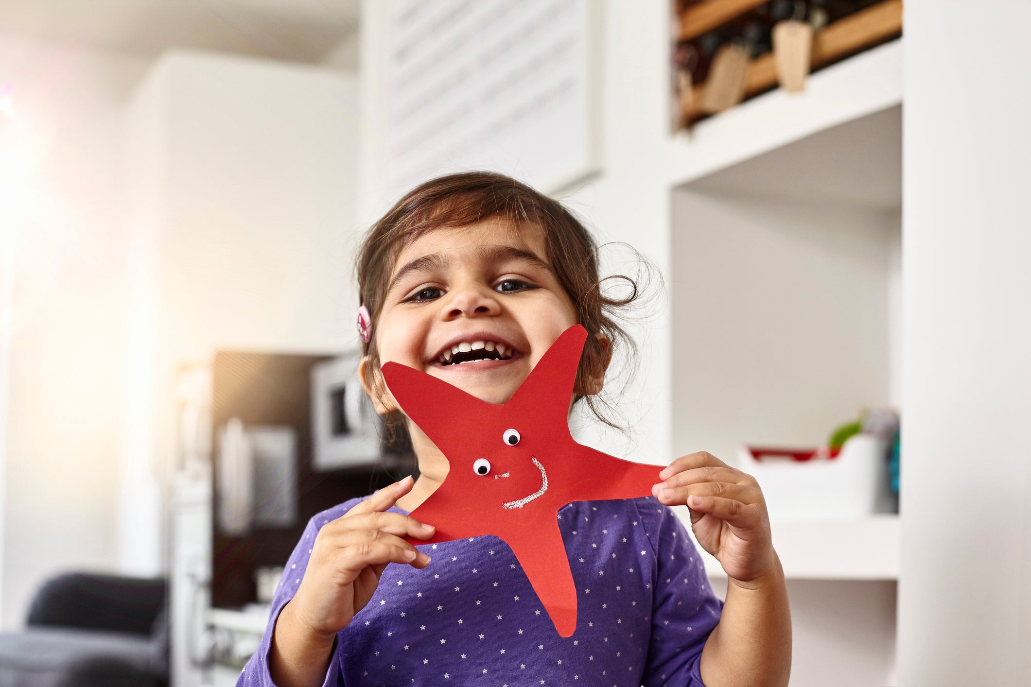 Smiling girl showing her self-made starfish
