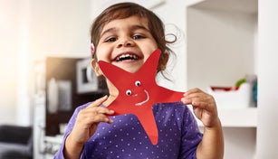 Smiling girl showing her self-made starfish