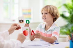 Kid learning to read. Phonics flash cards.