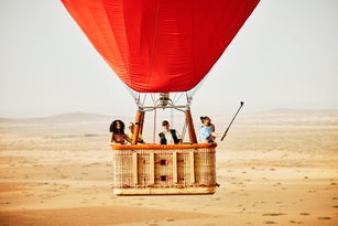 Wide shot of family and friends on early morning hot air balloon ride
