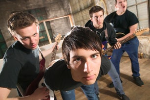 A four-man band posing