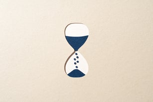 Blue Hourglass Passing Time on Beige Paper Cut Craft