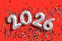 Silver balloons displaying 2026 with confetti on vibrant red background