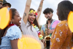 Group of multiethnic friends dancing in an open Air party.