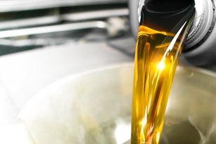 Pouring engine oil being added to a car engine