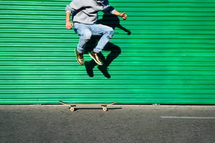Green wall skater - stock photo