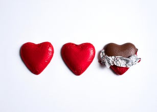 Close-Up Of Heart Shaped Chocolates On White Background