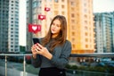 Young urban woman gets likes on social media