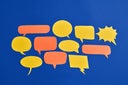 Many Orange And Yellow Comic Bubbles On Blue Background