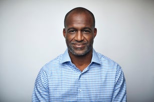 Mature businessman smiling over white background
