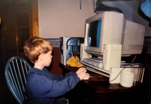 A Young Male Child Uses A 1996 Computer