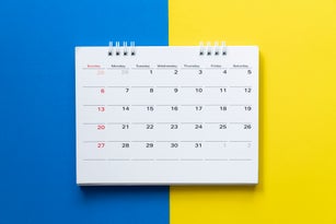 close up of calendar on the colorful table, planning for business meeting or travel planning concept