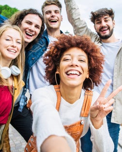 Multiracial group of friends taking selfie pic outside - Happy different young people having fun walking in city center - Youth lifestyle concept with guys and girls enjoying day out together