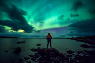 Norway, Lofoten Islands, Eggum, young man admiring northern lights