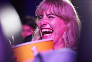 Cheerful woman enjoying at movie theater