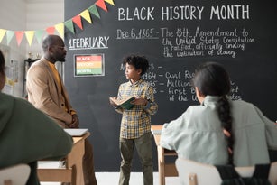 Schoolboy answering questions at lesson