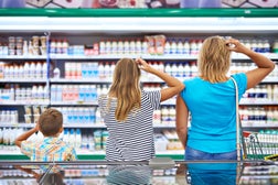 Family chooses dairy products in shop