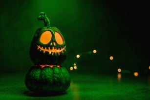 Halloween pumpkin jack o' lantern on acid green background