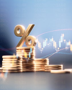 Percentage Sign On Top Of Coin Stacks Before Blue Financial Graph