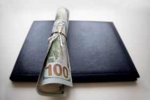 school diploma wrapped in $100 bills & traditional leather diploma binder