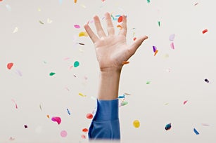 Businessman throwing confetti in the air