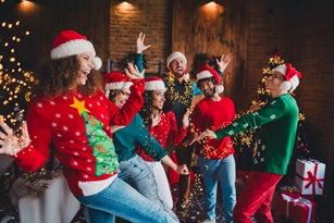 Photo of cheerful young people friends group good mood dancing cheerful smile cozy christmas party decor spacious apartment indoors