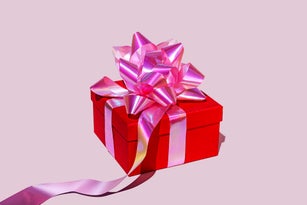 Red gift box against pink background