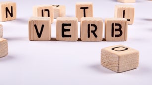 VERB. Wooden alphabet blocks on a white background