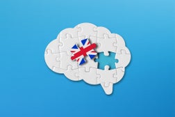 English learning concept, white jigsaw puzzle pieces with british flag a human brain shape on blue background