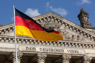 Deutscher Bundestag - Reichstag building with German flag (German parliament building) - Berlin, Germany