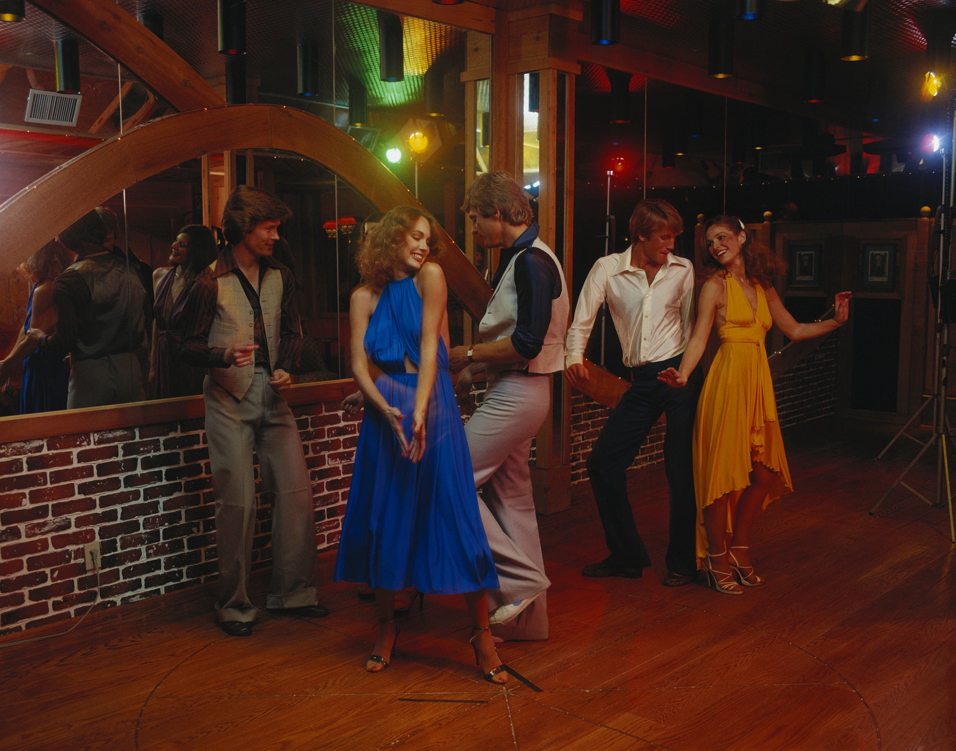 Couples dancing together at nightclub, smiling