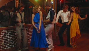 Couples dancing together at nightclub, smiling