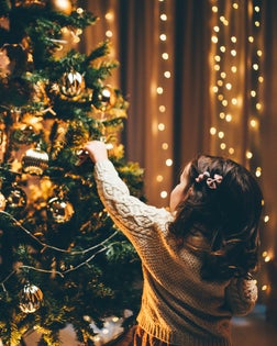 Little Girl Decorating Christmas Tree.