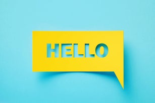 Hello Written Rectangular Shaped Yellow Chat Bubble On Turquoise Background