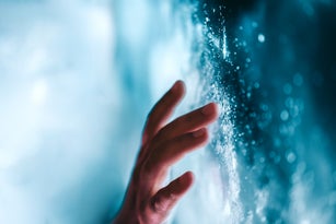 A person touching the digital portal. Interaction with the unknown and cosmic exploration