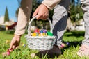 Woman laying down easter eggs from a basket