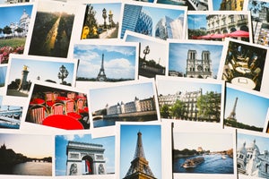 Collection of instant travel holiday photos of Paris on a table