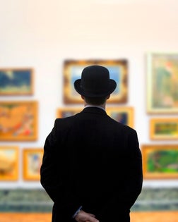Man wearing Bowler hat in gallery