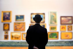Man wearing Bowler hat in gallery