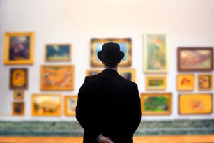 Man wearing Bowler hat in gallery