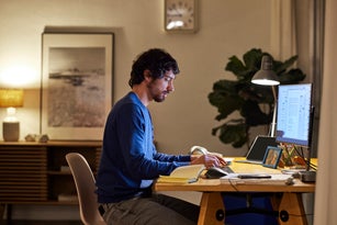 Male Entrepreneur Using Computer At Table